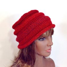 Hand knit in a gently marled red yarn, this striking hat is warm enough for all but the most frigid cold and light enough for anything other than summer's humid heat. The hat is knit from a soft acrylic yarn, making it perfect for people with sensitivity to animal fibers. Sized to fit about 21-22" circumference head (adult S or larger child) with a mildly loose fit, it has enough stretch that it's not too tight, and enough grip to stay on your head when the wind blows. The color is red with bits of brownish-purple twists in a very subtle striping pattern. The hat should be hand washed and dried flat to preserve color and shape; roll gently in a towel to squeeze out the excess water. Hats & other knits are rinsed & lightly blocked into shape before shipping. This hat is ready to to be shipp Purple Twists, Brownish Purple, When The Wind Blows, Yarn Making, Red Beanie, Red Yarn, Long Dangle Earrings, Slouchy Hat, Bucket Hats