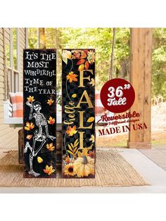 two tall halloween decorations are sitting on the front porch with fall leaves and pumpkins