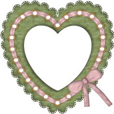 a green heart shaped wreath with pink ribbon and lights around it, hanging on a white wall