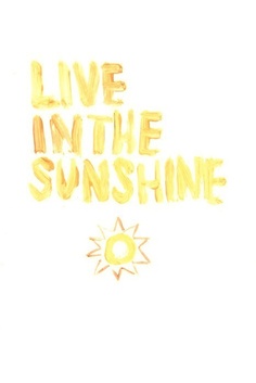 the words live in the sunshine are painted on white paper