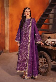 By Pcs: 3 Pcs Shirt: Twisted silk Trouser: Twisted silk Dupatta: Chiffon Color: Purple Product Details Let this purple outfit, with hints of aster's glamour, exude an aura of timeless allure. The meticulously embroidered shirt, a masterpiece in itself, features duo-toned mink and pink zari like stardust woven into the fabric. Light gold cupped sequins, sprinkled like dews on fallen aster petals, catch the light and whisper of forgotten wishes. A meticulously embroidered dupatta, a dreamlike casc Purple Salwar Kameez, Indian Dress Wedding, Dress Party Wear, Asim Jofa, Party Wear Dress, Pakistani Salwar Kameez, Purple Outfits, Stitch Shirt, Dress Indian