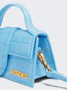 Small flap bag Structured crocodile-effect leather bag Padded top handle Magnetic flap tab closure Long removable strap Engraved lobster clasp Patch pocket on the back Topstitched details Gold metal logo and hardware Fully lined in cotton Dyed edges Luxury Turquoise Shoulder Bag With Top Handle, Luxury Blue Shoulder Bag With Magnetic Closure, Luxury Blue Shoulder Bag With Snap Closure, Luxury Light Blue Shoulder Bag With Gold-tone Hardware, Luxury Designer Blue Shoulder Bag, Luxury Modern Blue Flap Bag, Luxury Blue Flap Bag, Luxury Blue Leather Baguette Bag, Blue Luxury Flap Bag