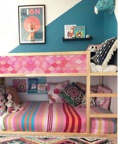 a child's bedroom with a bunk bed and colorful rugs