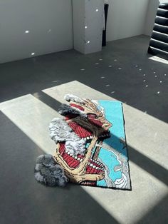 a rug with an image of a dragon on it in the middle of a room