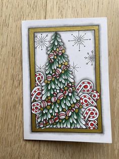 a card with a christmas tree on the front and an ornament in the back