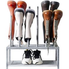 several pairs of shoes are lined up on a metal rack, with one shoe in the middle