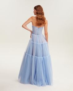 Dreamy tulle dress in light blue color with a light ruffled tulle maxi skirt. This dress has a heart-shaped boned semi-transparent bodice with built-in cups and a corset back, which makes the silhouette fitted and elegant. The A-line maxi skirt is made from multiple layers of delicate tulle that emphasize the hourglass silhouette. The waistline is adorned with a silver belt with Milla’s signature.This dress comes with straps, adding an elegant touch. Details: Material: Tulle Fabric composition: Asymmetrical Dress Casual, One Shoulder Dress Long, Winter Wedding Guest Dress, Tulle Maxi Dress, Tulle Maxi Skirt, Dress Weights, Rush Dresses, Corset Back, Blue Tulle