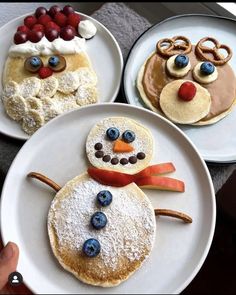 three plates with pancakes decorated to look like snowmen