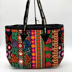 Attractive Color Combination. Mirror And Thread Work Done All Over The Tote. Black Cotton Fabric Lining Inside. One Small Inside Pocket With Zipper Closure. Zipper Closure On Top. Ethnic Tribal Design. Attractive Bright Color Combination. Size: 19”X12.5”X 5”. Handle Drop 10” Handmade By Tribe Azure Fair Trade Artisans. Exquisite Handmade Woven Unique Patchwork Tapestry And Mirrors.Each Bag Is Individually Made By Hand, Giving Each Bag A Unique Touch. Handicraft, Fair Trade, Bohemian, Banjara Bohemian Shoulder Bag For Shopping, Handmade Black Bohemian Bags, Multicolor Embroidery Beach Bags, Multicolor Embroidery Shoulder Bag For Beach, Embroidered Black Summer Bags, Black Embroidered Bags For Summer, Black Bohemian Rectangular Bag, Multicolor Embroidered Shoulder Bag For Summer Festivals, Bohemian Multicolor Shoulder Bag For Shopping