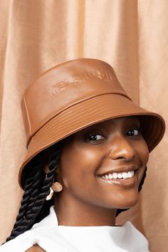 A caramel-brown bucket hat embossed with “Melanin-Rich”. Brown Bucket Hat, Leather Bucket Hat, Carmel Brown, Upcycled Fashion, Caramel Brown, Hair Breakage, Leather Bucket, Loose Powder, Free Bag