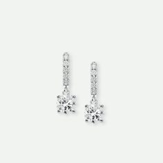 Our Anita earrings are beautiful and sophisticated. Exquisitely crafted in 18 carat white gold and set with a matched pair of round brilliant cut solitaires and a row of glittering pavé diamonds, they have a total diamond weight of 0.75ct. Product Information Metal Height (mm) Width (mm) Certificate 18ct white gold 14.5 4.5 Authenticity Certificate Lab Grown Diamond Information Total Carat Weight Colour Clarity Shape 0.75ct G VS2 Round Authenticity Certificate, Diamond Drop Earrings, Pave Diamonds, Round Brilliant, Lab Grown, Lab Grown Diamonds, Diamond Earrings, Lab, Diamonds