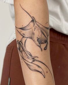 a woman's arm with a tattoo on it that has an image of a bird flying through the air