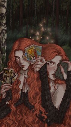 two red haired women sitting in the woods holding tarts and playing cards with each other