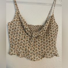 Purchased From A Boutique. Thought It Would Fit But The Chest Is Too Small For Me. Brand New Without Tags. It’s So Cute I Hate To Part With It But It Should Go To A Good Home. I Think It Would Be Adorable With A Midi Or Maxi Skirt Or High Waisted Pants. A Denim Jacket Or Cardigan Maybe. The Bow Knot Is Adjustable, Can Be Tied And Untied, The Straps Are Also Adjustable. Ruffle Around The Bottom. Spandex In Back Gives It Some Stretch. Details: Pit To Pit: 15” Underbust Laying Flat: 14” Strap Lengt Cute Beige Tops For Brunch, Feminine Brown Summer Tops, Brown Feminine Summer Tops, Feminine Fitted Top With Bow Straps, Fitted Cropped Top With Bow, Feminine Tie-back Cami Top, Feminine Pink Tie-back Top, Summer Bow V-neck Top, Front Crop Top