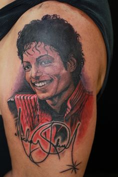 the back of a man's shoulder with an image of michael jackson on it