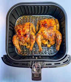 two chicken legs on top of an air fryer