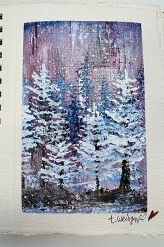 an art journal is open to show a painting of trees in the snow with purple and blue hues