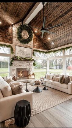 a living room filled with furniture and a fire place in the middle of an open floor plan