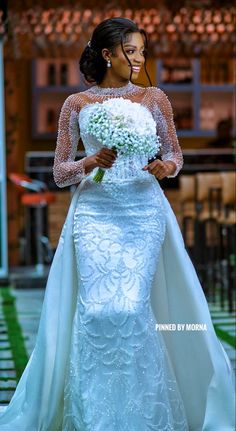 a woman in a wedding dress holding a bouquet