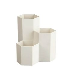 three white vases sitting next to each other