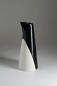 a black and white vase sitting on top of a table