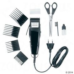 a hair clipper, combs, and other items are arranged on a white surface