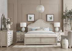 a white bed sitting in a bedroom on top of a hard wood floor next to two lamps