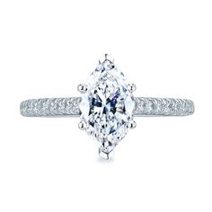 an engagement ring with a cushion cut diamond in the center