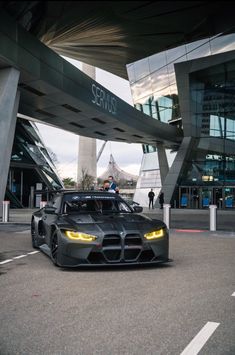 a black sports car parked in front of a building