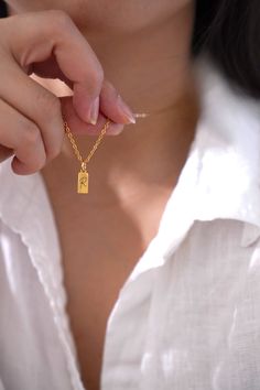 18k Gold Plated Dainty Charm pendant hangs on a sturdy 18K gold plated stainless steel chain. This necklace can be further personalized by engraving your initial or birth flower. See photo listing for options.  You choose your necklace length from the drop-down menu. Model wears 18 inches gold chain. DETAILS Dainty Rectangle Gold Charm measures 5x10mm LENGTH CUSTOMIZATION You may choose your desired length from the drop-down menu or contact me for length customization. QUALITY My designs are tested and proven. My jewelry are made from 316L premium stainless steel, very strong and durable. They are hypoallergenic; very comfortable for sensitive skin and can last for many years and still retain the shiny appearance.  GIFT All items are beautifully gift wrapped! If this is a gift for a specia Gold Flower Pendant Necklace As Gift For Mom, Gold Dainty Initial Necklace For Mom, Dainty Gold Initial Necklace As Gift For Mom, Gold Plated Necklaces With Flower Charm As Gift, Gold Necklace With Flower Charm Gift For Her, Gold Necklace With Flower Charm As Gift For Her, Gold Rectangular Pendant Jewelry Gift For Mom, Gold Rectangular Pendant Jewelry As Gift For Mom, Gold Initial Pendant Necklace As Gift For Mom