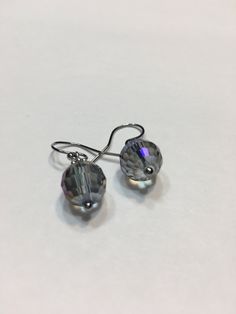 "Blue Aurora Borealis 10mm faceted disco ball glass beads, stainless steel hook wire dangling earrings. 1\" top to bottom, dangle 1/2 inches. Hand made Jewelry! Thanks for stopping by!" Nickel-free Crystal Earrings For Party, Nickel-free Round Crystal Earrings For Party, Hypoallergenic Round Crystal Earrings For Party, Faceted Crystal Party Earrings, Glass Faceted Beads Earrings For Gift, Nickel Free Czech Glass Beaded Earrings For Party, Nickel-free Czech Glass Beaded Earrings For Parties, Adjustable Crystal Earrings With Faceted Beads, Glass Earrings With Faceted Beads For Gift