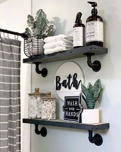 the bathroom is decorated in black and white with lots of items on shelves above it