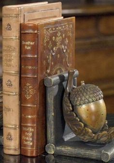 two books are sitting next to each other on a table with an owl figurine