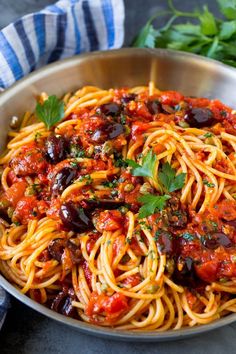 a bowl filled with spaghetti and olives