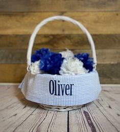 a white basket with blue and white flowers in it