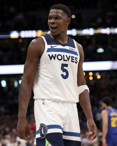 a basketball player standing on the court with his hands in his pockets and mouth open