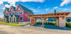 a pink house with a pergolan attached to it