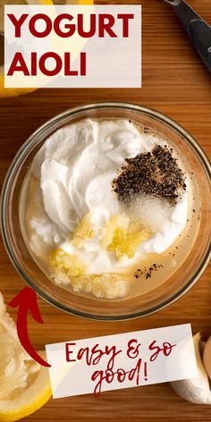 yogurt is in a glass bowl on a wooden table with an orange slice