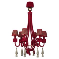 a red chandelier hanging from the ceiling with four lights on it and tassels