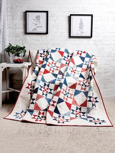 a red, white and blue quilt sitting on top of a table