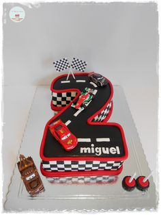 a birthday cake made to look like a number two with cars on the front and back