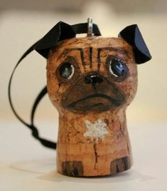 a small wooden toy with a black hat on top of it's head and eyes