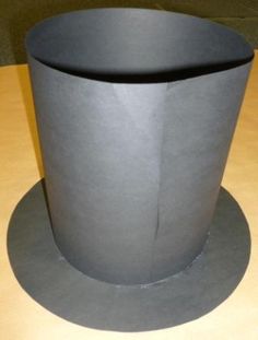 a gray cup sitting on top of a wooden table