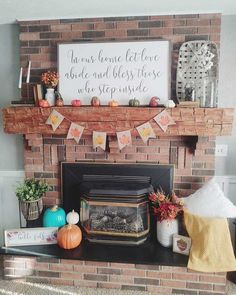 a brick fireplace with fall decorations on the mantle