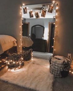 a bedroom with lights strung from the ceiling and rugs on the floor in front of it