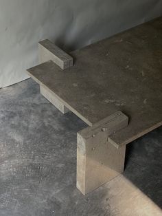 a concrete bench sitting on top of a cement floor