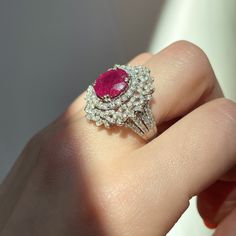 18KT White Gold Oval Ruby + Pave Diamond ring Size 8 Can be resized for an additional fee Large Statement Ring Lovely intricate design This an absolutely lovely attention getting piece! Round and Baguette Diamonds with Oval Faceted Ruby Ring. Approx 4.83 CT Ruby 10.7 x 9.9x 5.7 mm 2.20 CT Diamond Approx 9.8 grams 18KT Stamped Abrasions to the Ruby, which could be polished out by a stone cutter. We can quote for that if need b3, but this ring is so pretty, it really does not need. Check out all o Luxury Oval Ruby Diamond Ring, Luxury Marquise Ruby Ring, Luxury Oval Ruby Ring With Halo Design, Dazzling Oval Ruby Ring With Diamonds, Luxury Marquise Ruby Ring With Diamonds, Luxury Oval Ruby Ring, Luxury Ruby Ring With Oval Center Stone, Exquisite Oval Ruby Ring In White Gold, Luxury Oval Ruby Ring With Center Stone