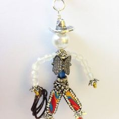 a necklace with an image of a man wearing a hat and holding a guitar string