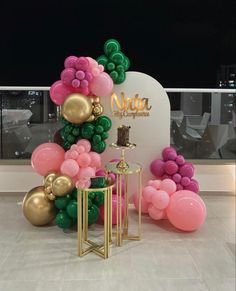 balloons and tables in front of a sign