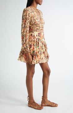 An allover print enlivens this frill-trimmed dress elevated in luxurious silk and fronted with a deeply dipped neckline. 34 1/2" length (size 8) Deep V-neck Long sleeves Smocked waist Lined 100% silk Dry clean Imported Multicolor Ruched Dress For Daywear, Multicolor Ruched Silk Dress, Spring Silk Dress With Gathered Neckline, Silk Mini Dress With Ruffles And Long Sleeves, Elegant Tiered Mini Dress With Floral Print, Elegant Multicolor Ruched Mini Dress, Printed Silk Daywear Dresses, Elegant Flowy Printed Mini Dress, Spring Silk Dress With Smocked Bodice